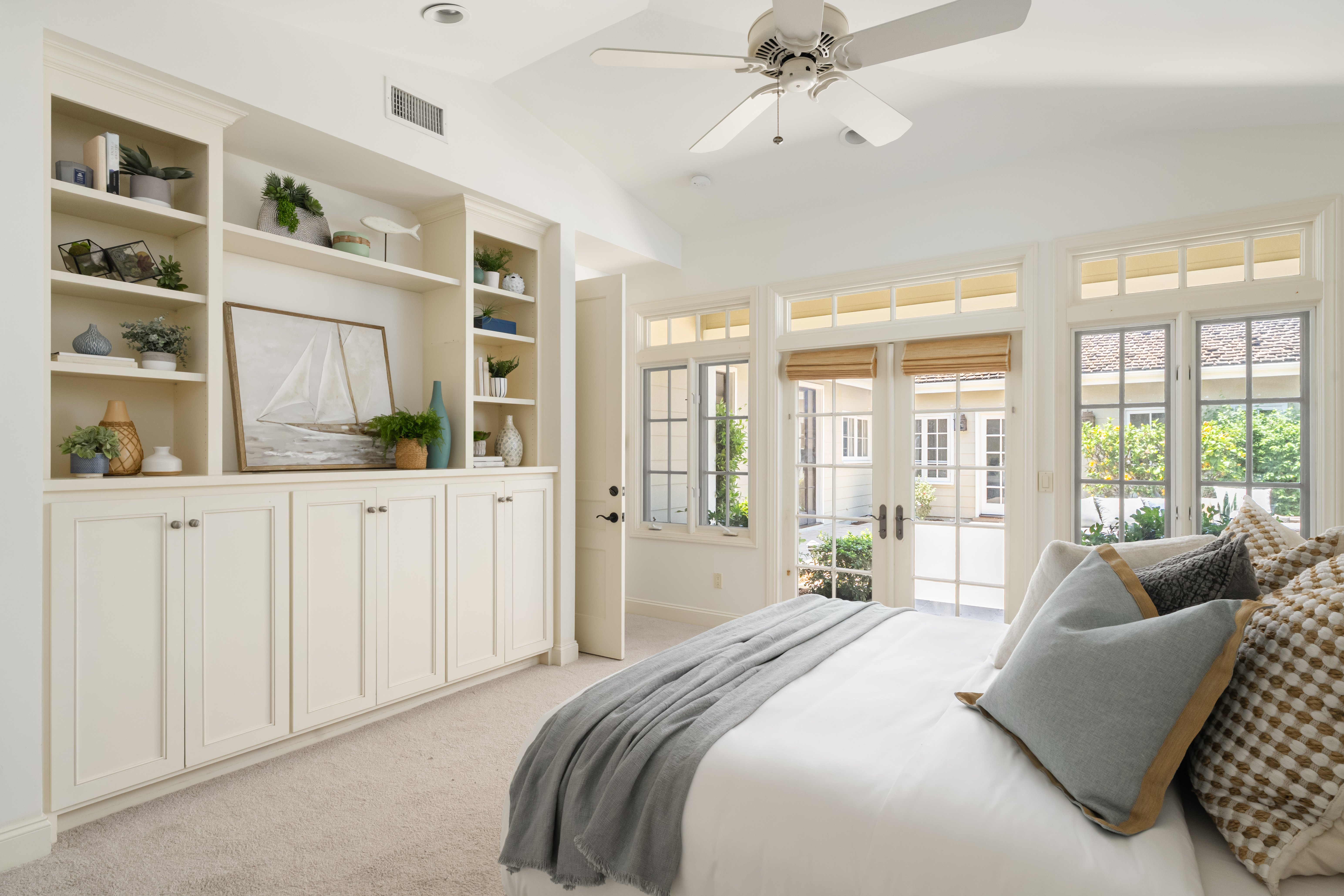 La Jolla staged bedroom built-in shelving French doors