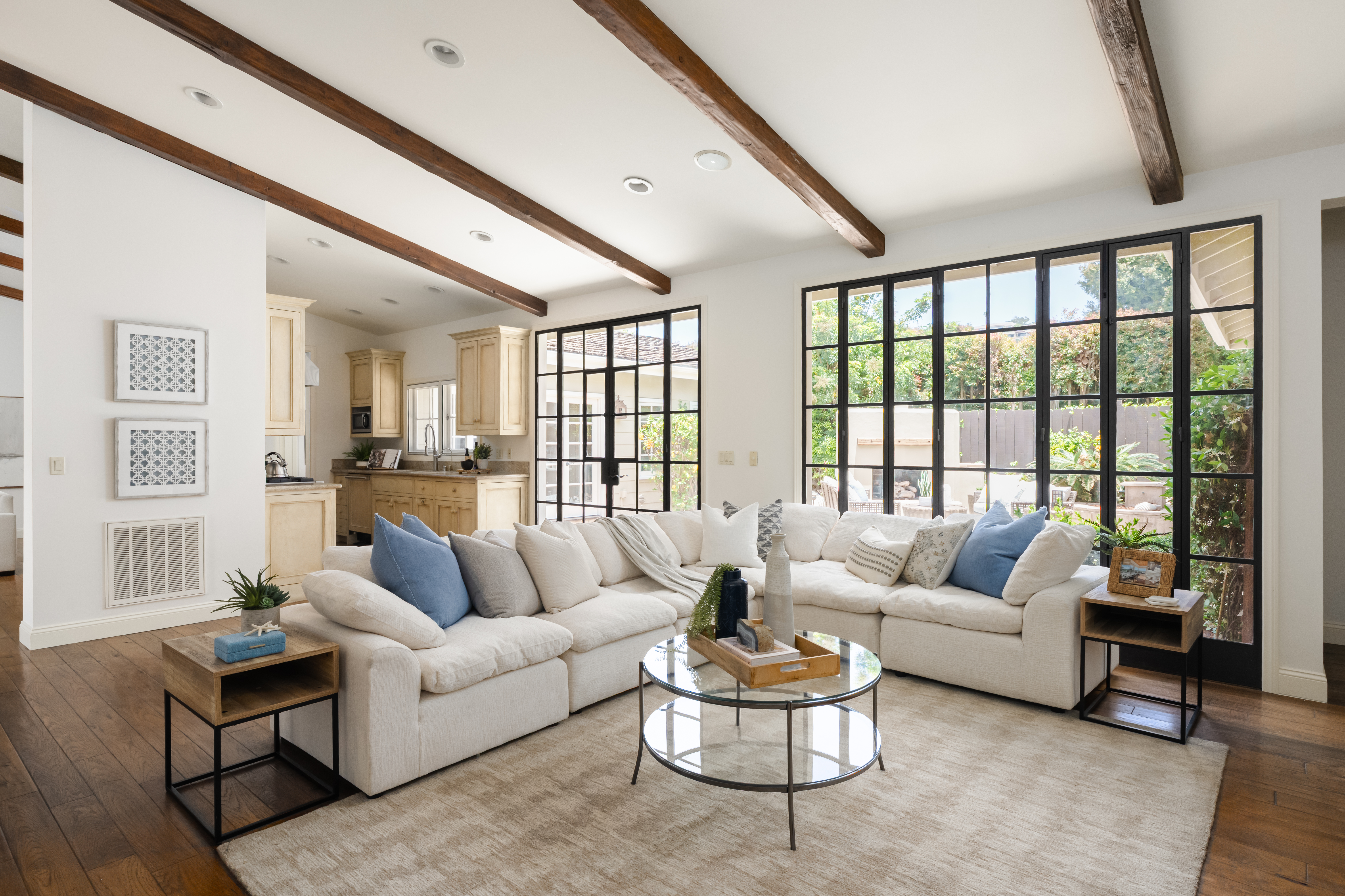 Occupied home staging La Jolla living room steel windows wood beams